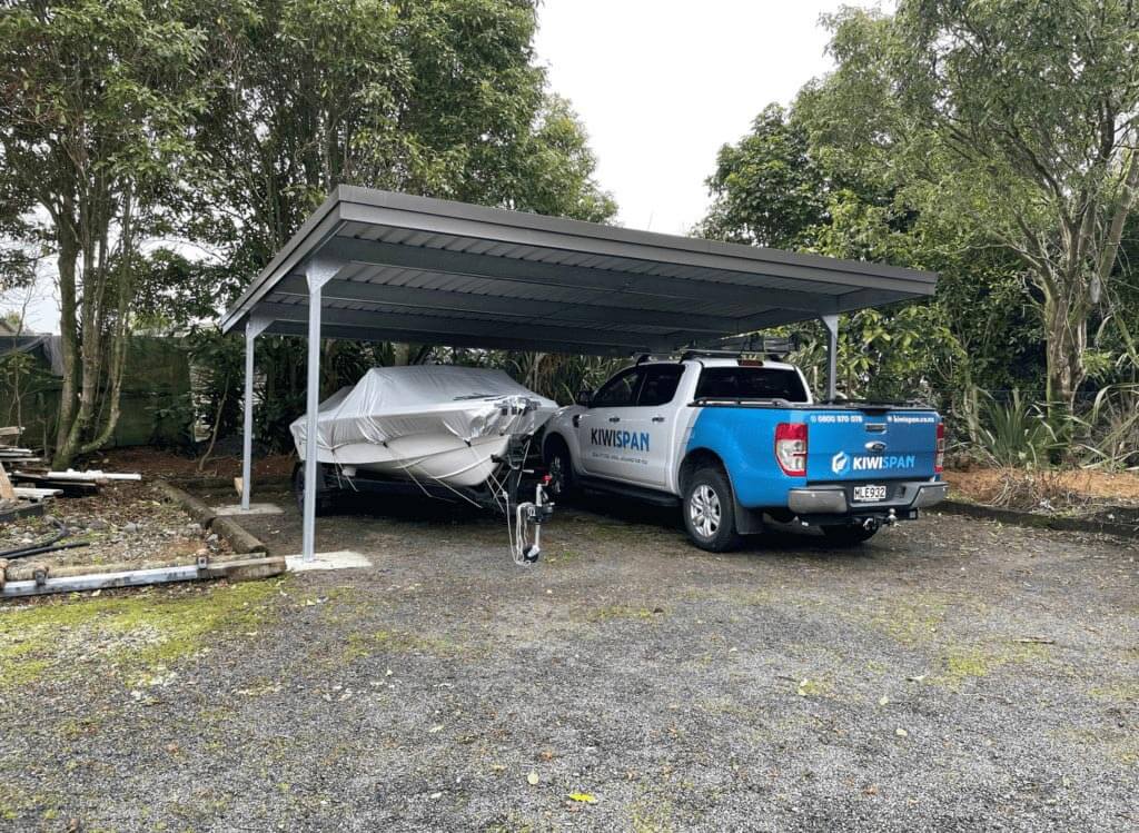 large residential carport with boat and ute truck