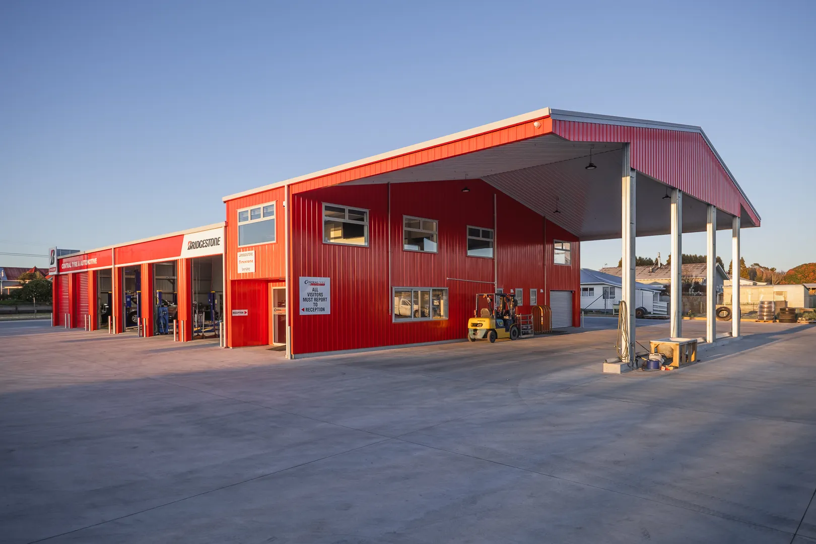 Red Bridgestone commercial steel shed made by KiwiSpan