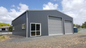 Storage shed with two doors, Thunder Grey Slimclad cladding and gable roof built by KiwiSpan