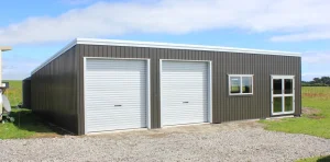White two door KiwiSpan storage shed with windows on rural property
