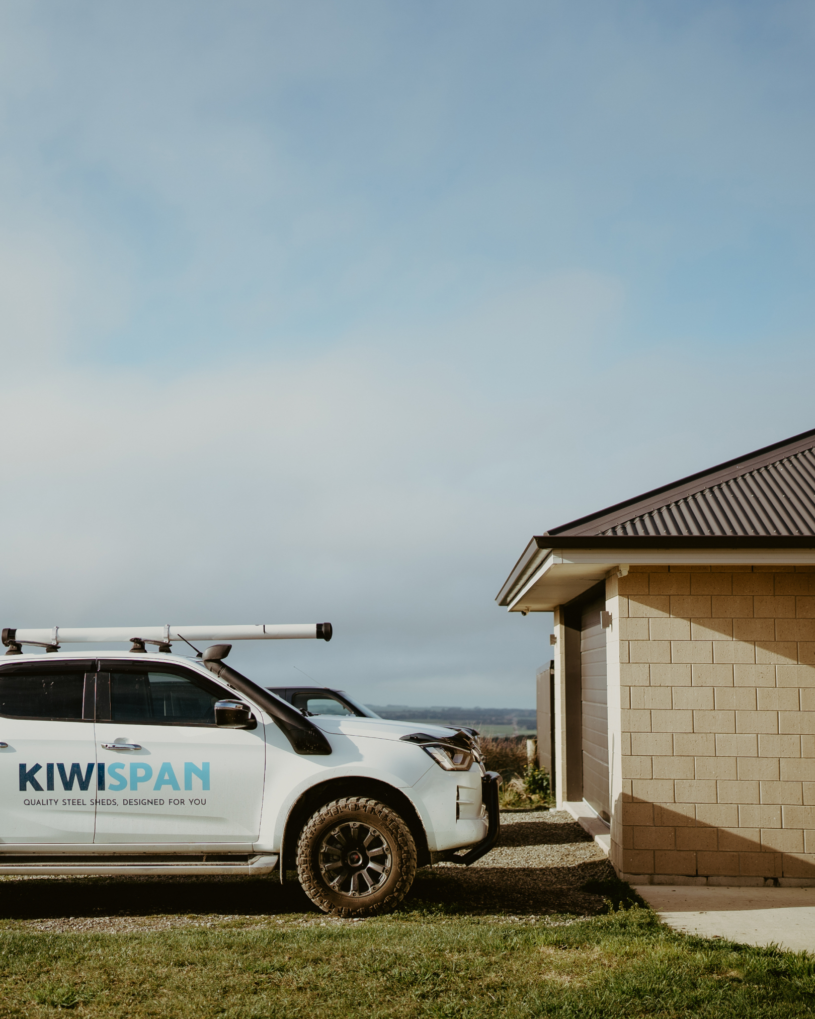 kiwispan vehicle beside house